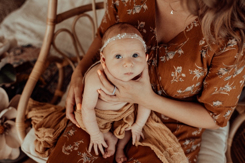 Bay Area Newborn Photography, mother holding up baby's face to the camera