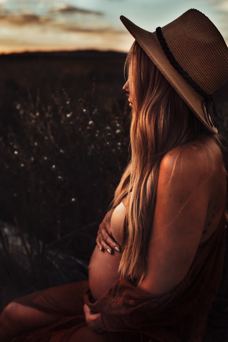 Bay Area Maternity Photography, mother sitting in field during sunset