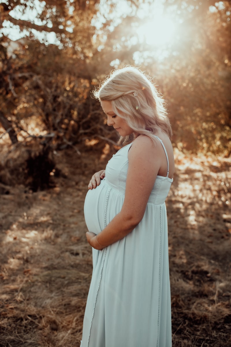 Bay Area Maternity Photography, woman in white dress holding her belly