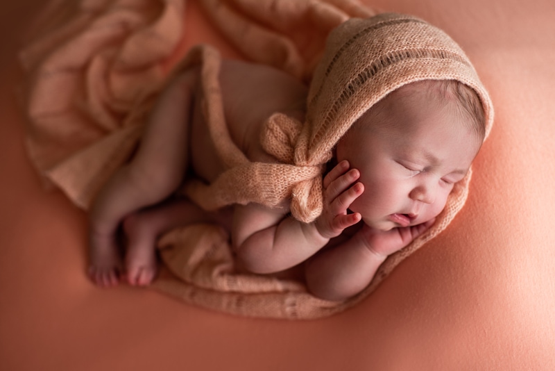 Bay Area Newborn Photography, baby on blush background wrapped in blanket