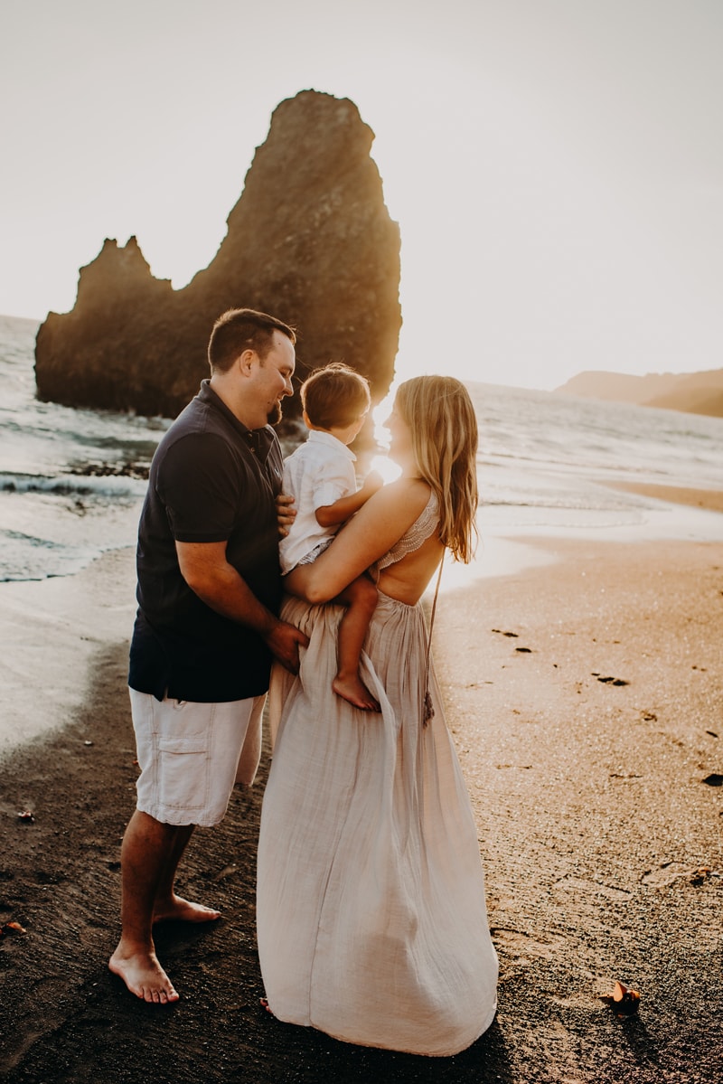 Bay Area Maternity Photography, family of three standing in the sand at the beach with sunset