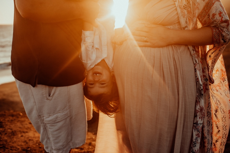 Bay Area Maternity Photography, father holding little boy upside down next to mother's belly